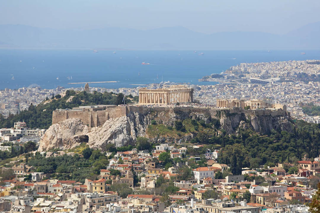 Clear blue sky and sea with Saronic Gulf in background and the Acropolis clearly seen